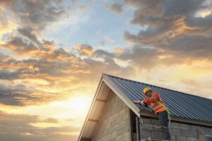 A homeowner views a roof pitch diagram beside a snow-covered house with visible rafters in an attic.